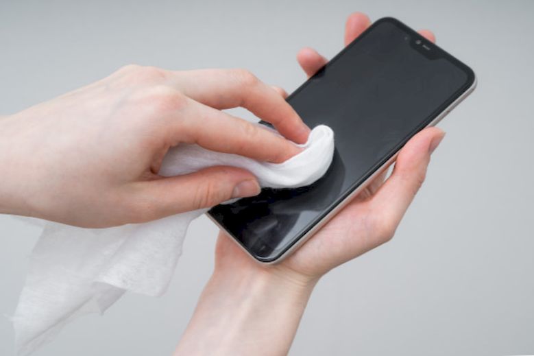 A man cleans his smartphone